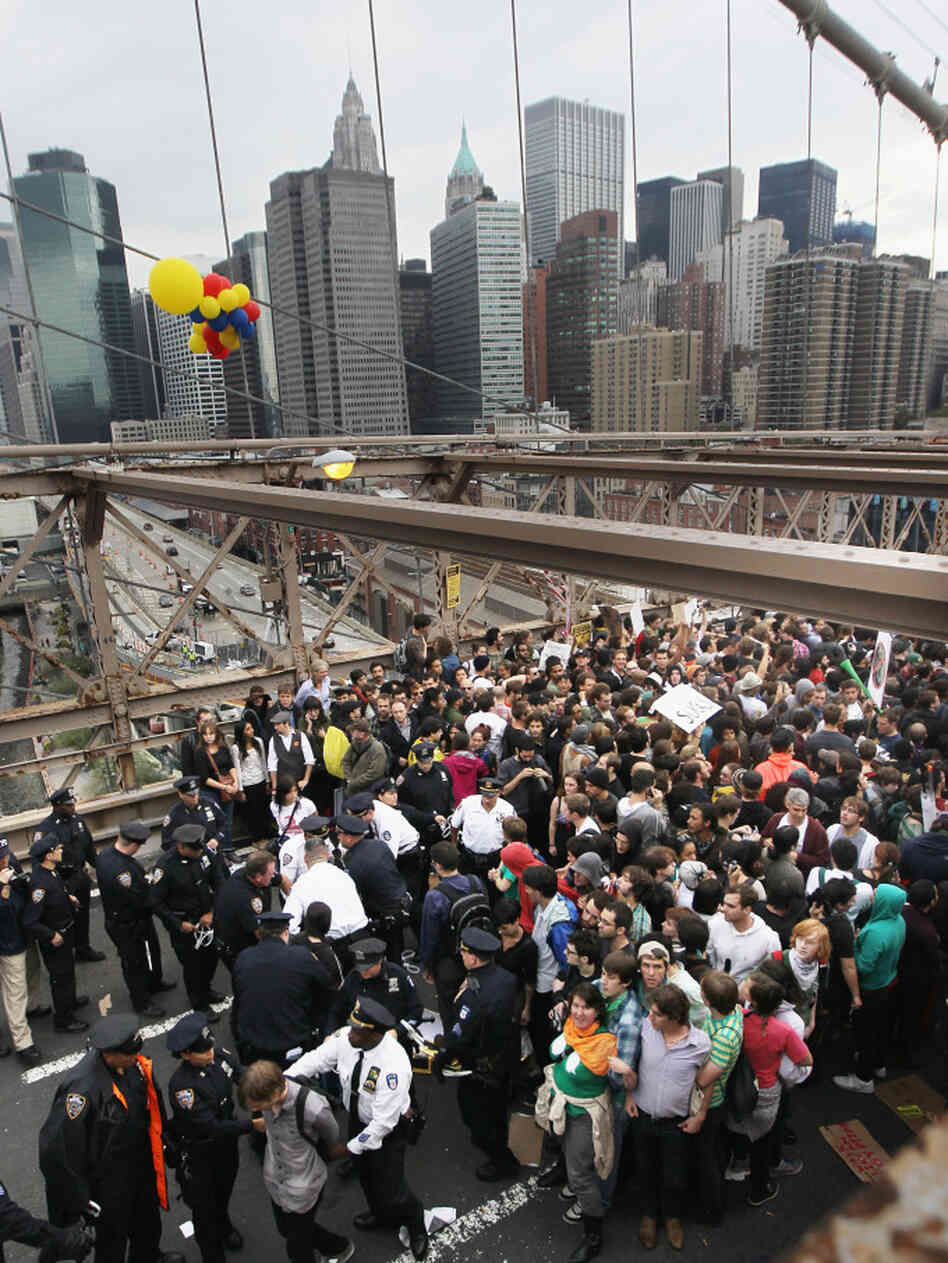Police arrest two Occupy Wall Street demonstrators after they tried to cross the Brooklyn Bridge on Oct. 1. Media coverage spiked after the incident.