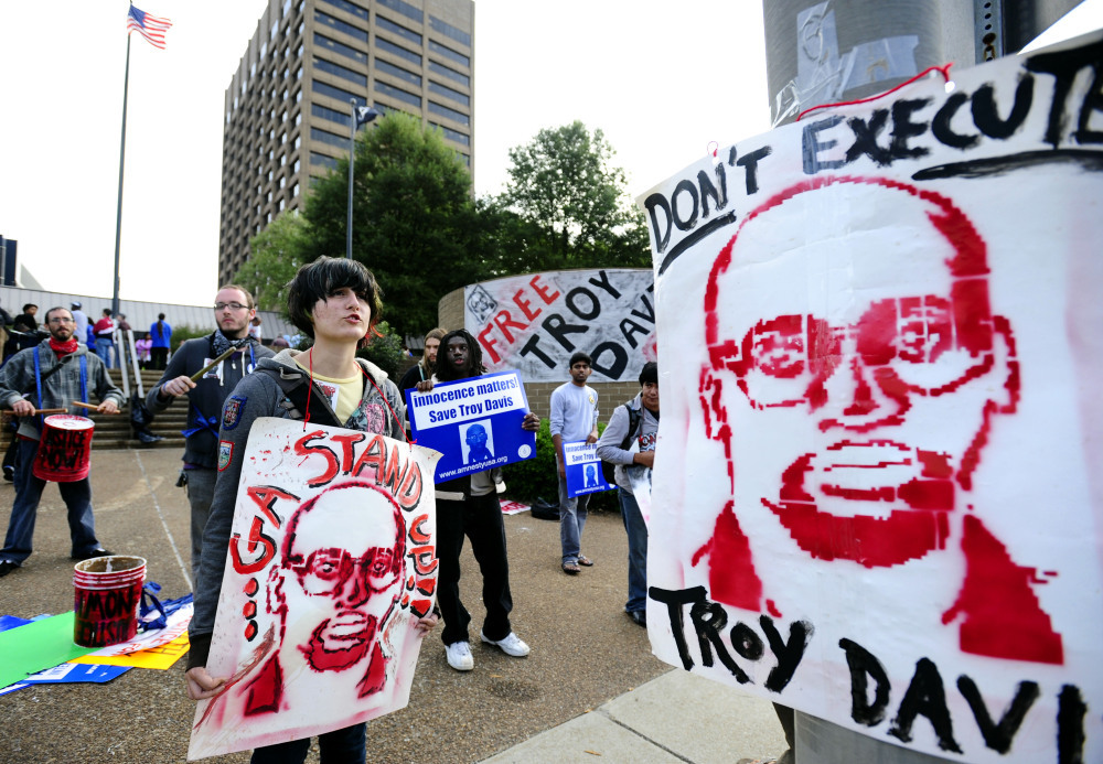 <p>Protesters gather outside the building where Georgia Board of Pardons and Paroles members held a hearing for death row inmate Troy Davis in Sept. 2011. </p>
