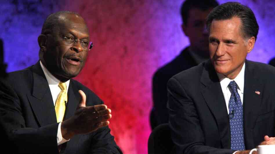Business executive Herman Cain, left, and former Massachusetts Gov. Mitt Romney during a debate Tuesday (Oct. 11, 2011) in New Hampshire. 