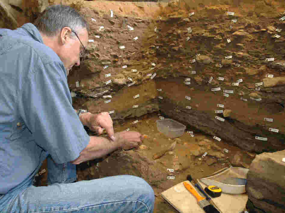 Archaeologist Christopher Henshilwood excavates at the 100,000-year-old levels of the Blombos cave in South Africa.