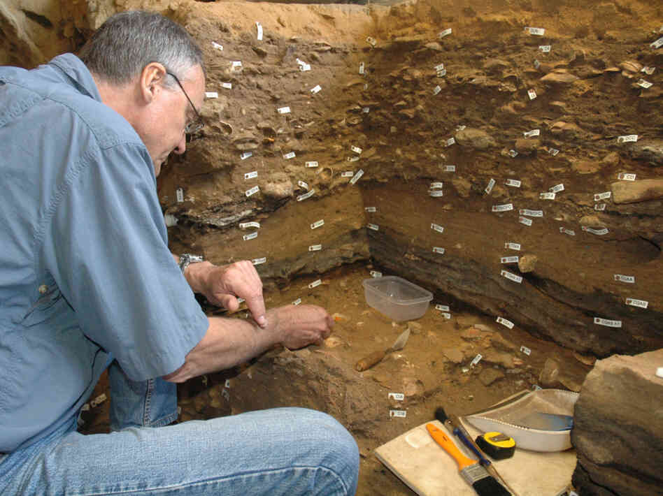 Archaeologist Christopher Henshilwood excavates at the 100,000-year-old levels of the Blombos cave in South Africa.