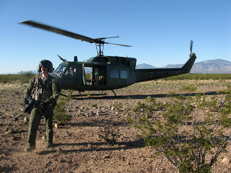 A member of a helicopter flight crew participating in Operation Angel Thunder walks across the desert in southern Arizona.