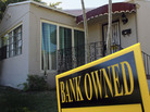 A bank-owned sign is seen in front of a foreclosed home in Miami. Florida was among the hardest hit states in the real estate collapse. A bank-owned sign is seen in front of a foreclosed home in Miami. Florida was among the hardest hit states in the real estate collapse.