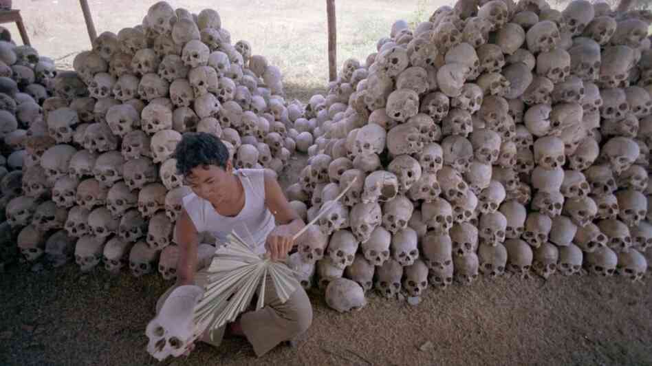 In this undated photo, a man cleans a skull near a mass grave at the Choeung Ek camp outside Phnom Penh, Cambodia — the best known of the killing fields run by the Khmer Rouge in the middle and late 1970s. Now, Cambodians are skeptical that a U.N.-backed tribunal will be able to deliver justice in the case of four remaining high-level Khmer Rouge officials.