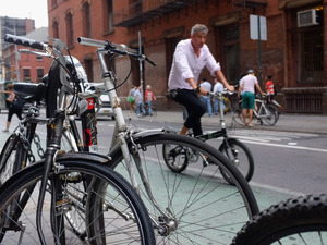 A man rides down a Manhattan street on a bicycle in New York City. A man rides down a Manhattan street on a bicycle in New York City.