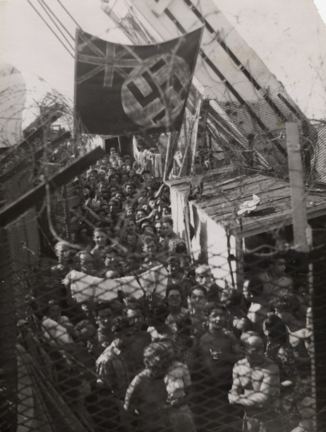 1,500 Jewish refugees, having been forced off Exodus 1947 in Haifa, Palestine, wait aboard the British prison ship Runnymede Park. In protest, the prisoners painted a swastika on top of the Union Jack. August 22, 1947 1,500 Jewish refugees, having been forced off Exodus 1947 in Haifa, Palestine, wait aboard the British prison ship Runnymede Park. In protest, the prisoners painted a swastika on top of the Union Jack. August 22, 1947
