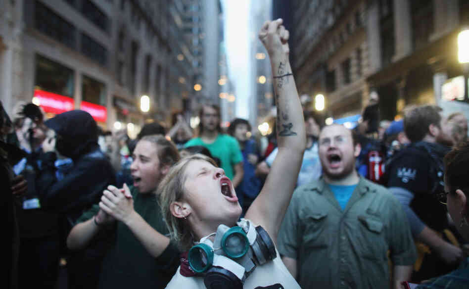 Demonstrators associated with the Occupy Wall Street movement face off with police Friday in the streets of New York City's financial district.