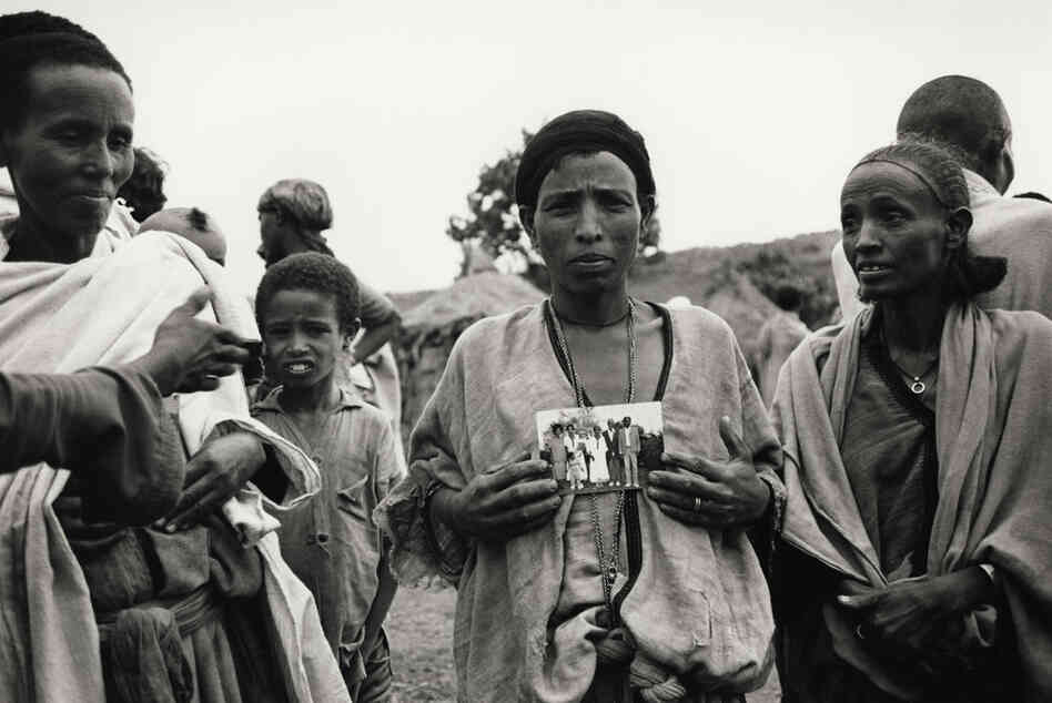 An Ethiopian Jewish mother with a photograph of her children, who had already immigrated to Israel, Ethiopia, 1985