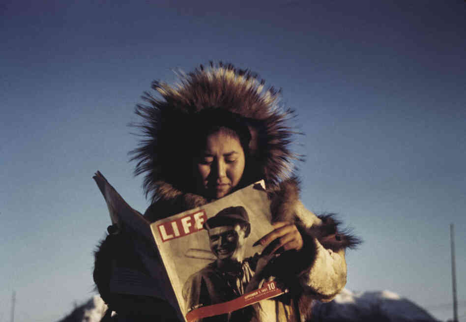 Eklutna woman reading Life Magazine, Hooper Bay, Alaska, 1941-43