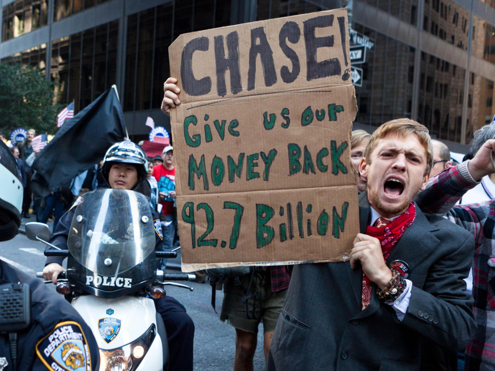 As many as 1,000 Occupy Wall Street protesters marched to a Chase bank in New York's financial district to decry corporate greed.