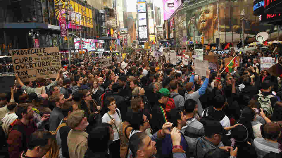 Demonstrators protest in New York's Time Square on Saturday. Thousands of people took to the streets in cities across the world, inspired by the Occupy Wall Street protests against economic inequality.