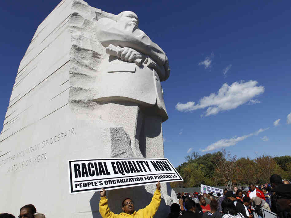 Demonstrators rally under the new Martin Luther King Jr. memorial in Washington, D.C., on Saturday.