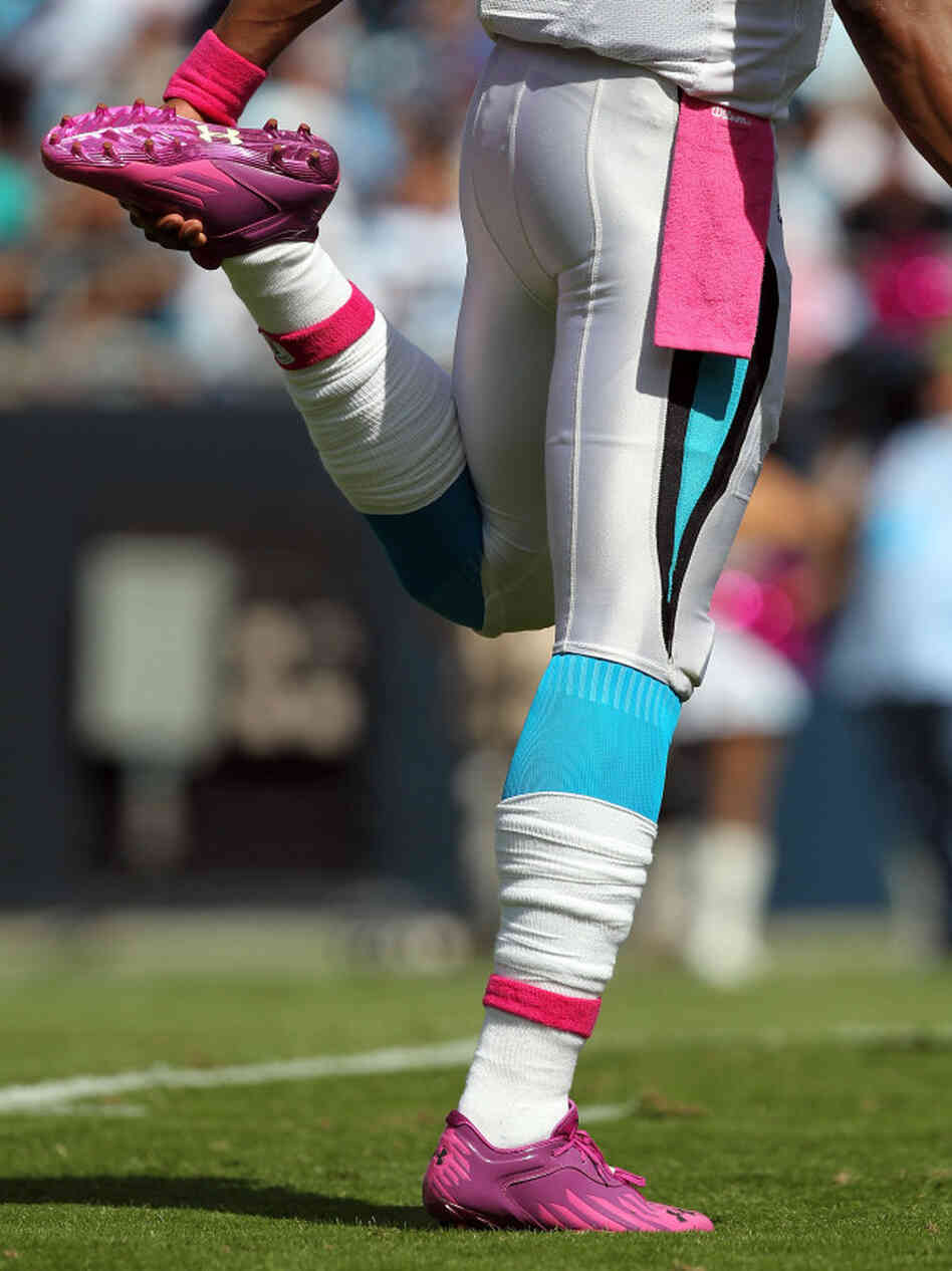 Cam Newton #1 of the Carolina Panthers stretching as he wears pink for breast cancer awareness during their game at Bank of America Stadium in October.
