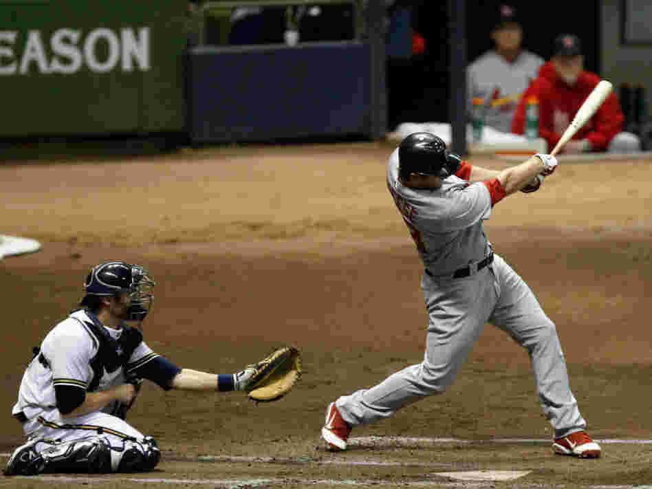 David Freese of the St. Louis Cardinals hits a 3-run home run in the top of the first inning against the Milwaukee Brewers.