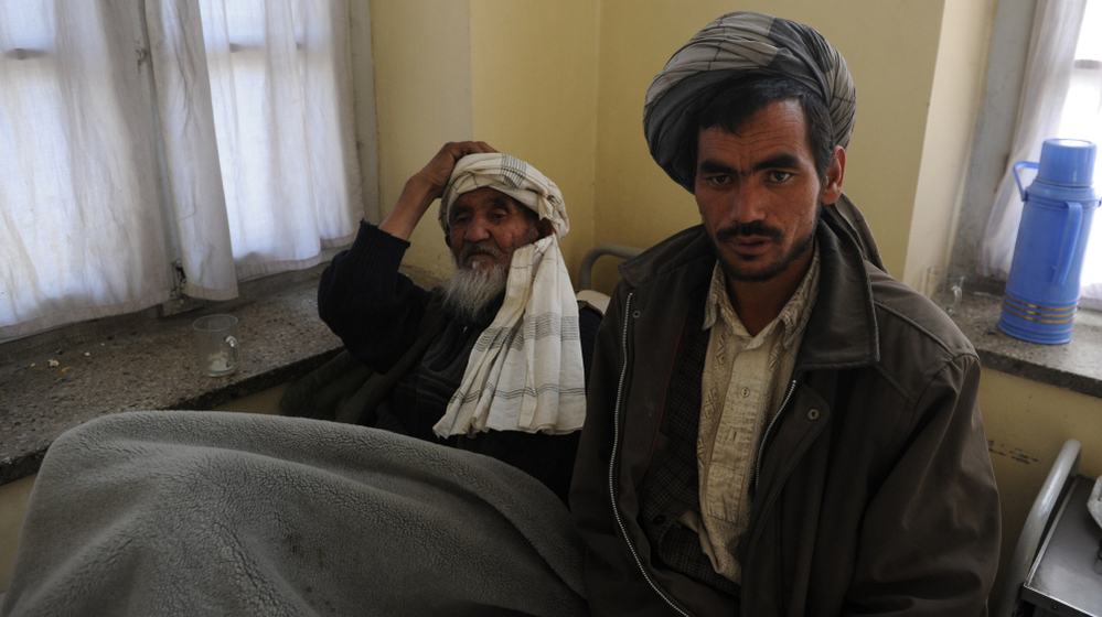 Afghan men wait to receive psychiatric treatment in a Kabul hospital. Scarred by decades of war, social problems and poverty, more than 60 percent of Afghans suffer from stress disorders and mental health problems.