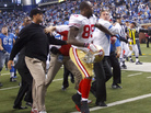 Harbaugh (in dark cap and jacket) and Schwartz (in white jacket with blue stripes) are separated by the 49ers' Venron Davis (85). Harbaugh (in dark cap and jacket) and Schwartz (in white jacket with blue stripes) are separated by the 49ers' Venron Davis (85).