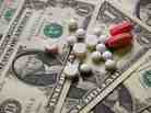 Drugs or pills against a background of dollar bills.
