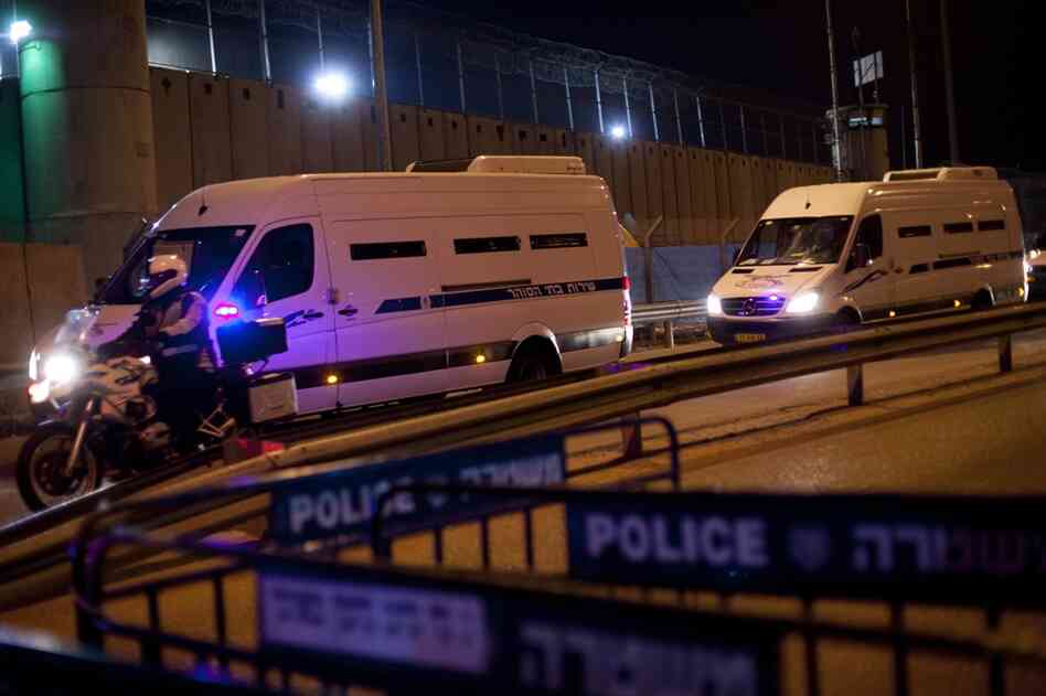 A convoy of Israeli Prison Service buses arrives at Israel's Ofer prison in the early morning hours to transport Palestinians prisoners. 