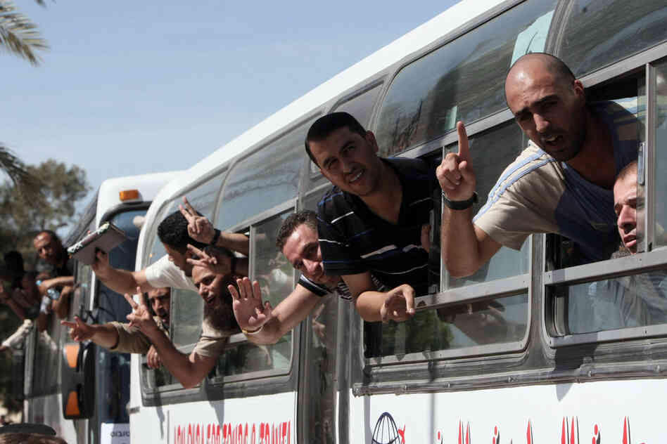 Palestinian prisoners cross from Egypt into the Gaza Strip on Tuesday after they were released from Israeli jails in a landmark prisoner swap. 