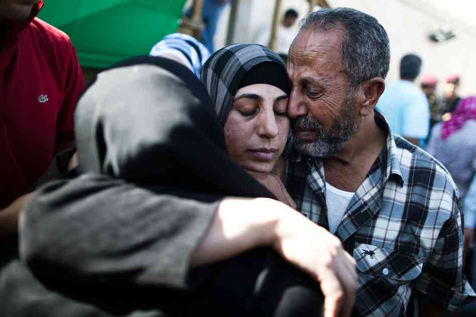 A Palestinian prisoner hugs relatives after arriving in Mukata following her release in Ramallah. A total of 27 women were set free Tuesday. 