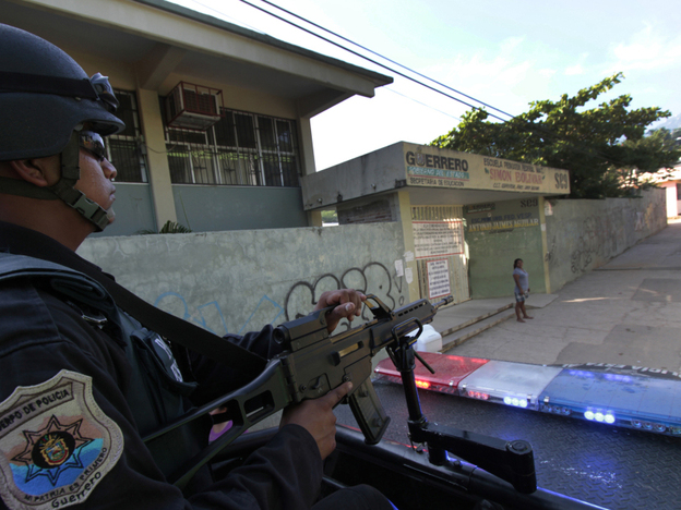 A federal policeman in Mexico patrols the outskirts of Acapulco, Guerrero state, earlier this month. Acapulco has seen a sharp drop in tourism as criminals battle for control of the city. 