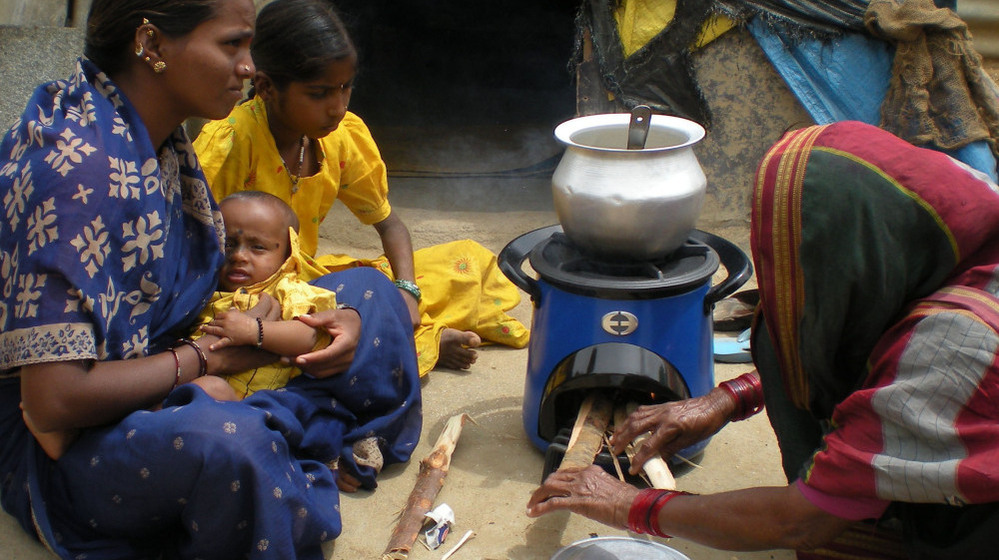 Women in India using an Envirofit clean cookstove to reduce indoor air pollution