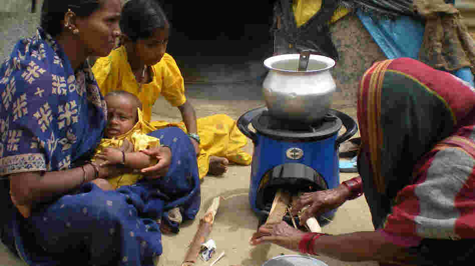 Women in India using an Envirofit clean cookstove to reduce indoor air pollution