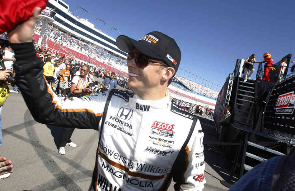 Dan Wheldon, of England, smiles during driver introductions for the IndyCar Series Las Vegas Indy 300 auto race Sunday, Oct. 16, 2011, in Las Vegas. Wheldon, a two-time Indianapolis 500 winner, died following a crash in the race. 