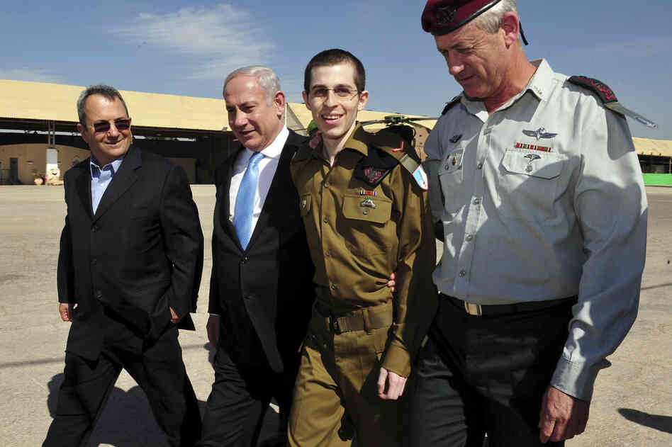 Released Israeli soldier Gilad Shalit, (second right), walks with Israeli Prime Minister Benjamin Netanyahu, (second left), Defense Minister Ehud Barak, and Israeli Chief of Staff Lt. Gen. Benny Gantz, on Tuesday. Schalit returned home  from more than five years of captivity in the Gaza Strip. 