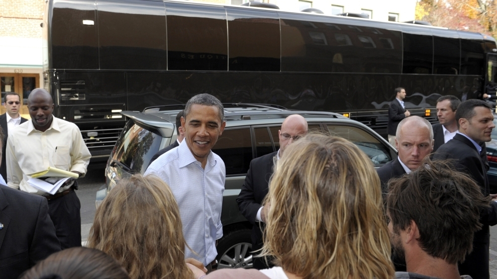 With his bus in the background, President Barack Obama greets people outside of Mast General Store in Boone, N.C., Monday. Obama is on a three-day bus tour promoting the American Jobs Act. 