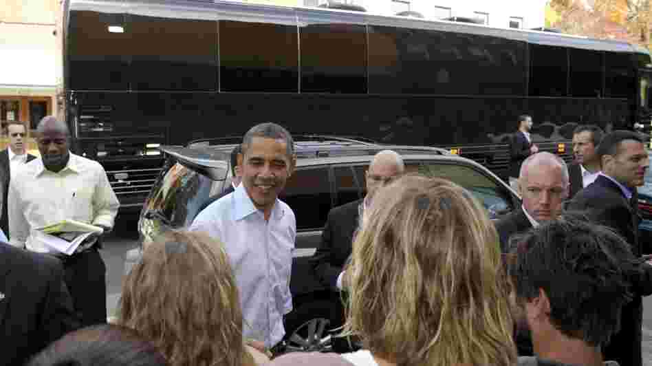 With his bus in the background, President Barack Obama greets people outside of Mast General Store in Boone, N.C., Monday. Obama is on a three-day bus tour promoting the American Jobs Act. 