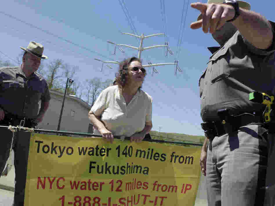 Marilyn Elie (center) of Cortlandt Manor, N.Y., is escorted off the grounds of the Indian Point Energy Center during a protest in May. Elie was there with a half-dozen others to voice opposition to the re-licensing of the nuclear facility. 