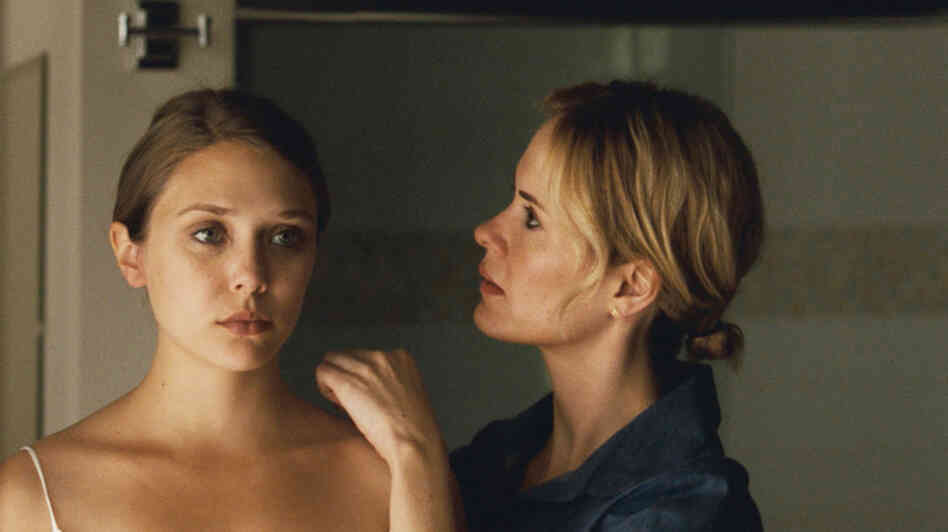 Elizabeth Olsen (left) plays Martha — or is she Marcy? May or Marlene? — a strained and strange young woman who has fled a cult's rural commune to take refuge with her sister (Sarah Paulson). Elizabeth Olsen (left) plays Martha — or is she Marcy? May or Marlene? — a strained and strange young woman who has fled a cult's rural commune to take refuge with her sister (Sarah Paulson).