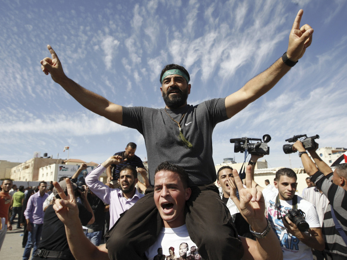 Palestinians celebrate the release of prisoners in the West Bank city of Ramallah. A total of 477 Palestinians were freed Tuesday, with 550 more slated to be released in two months.