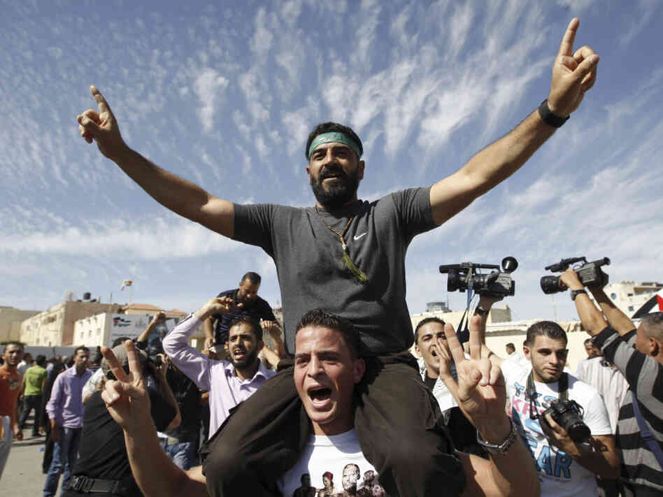 Palestinians celebrate the release of prisoners in the West Bank city of Ramallah. A total of 477 Palestinians were freed Tuesday, with 550 more slated to be released in two months.