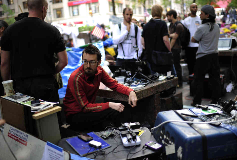 Occupy Wall Street volunteers man a communication station in Zuccotti Park near Wall Street on Oct. 11. The media team monitors Twitter and Facebook and oversees the group's Livestream feed. Occupy Wall Street volunteers man a communication station in Zuccotti Park near Wall Street on Oct. 11. The media team monitors Twitter and Facebook and oversees the group's Livestream feed.