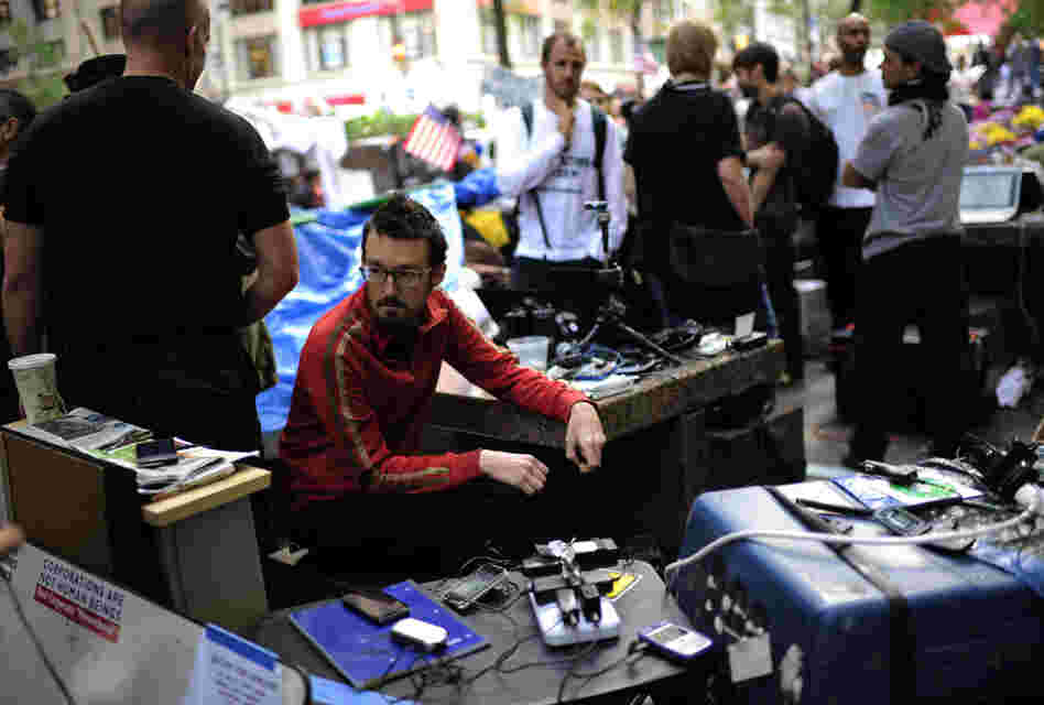 Occupy Wall Street volunteers man a communication station in Zuccotti Park near Wall Street on Oct. 11. The media team monitors Twitter and Facebook and oversees the group's Livestream feed. Occupy Wall Street volunteers man a communication station in Zuccotti Park near Wall Street on Oct. 11. The media team monitors Twitter and Facebook and oversees the group's Livestream feed.