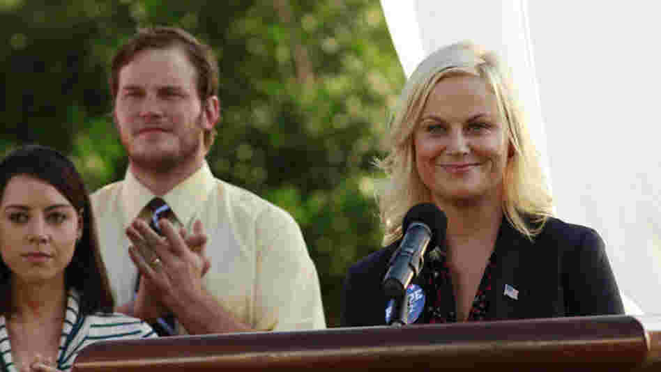Amy Poehler, seen here with Aubrey Plaza as April Ludgate and Chris Pratt as Andy Dwyer, plays idealistic bureaucrat Leslie Knope on NBC's Parks And Recreation.