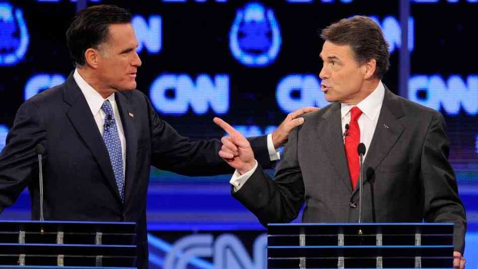 Former Massachusetts Gov. Mitt Romney (left) and Texas Gov. Rick Perry got into a heated exchange about immigration during Tuesday's GOP presidential debate in Las Vegas.