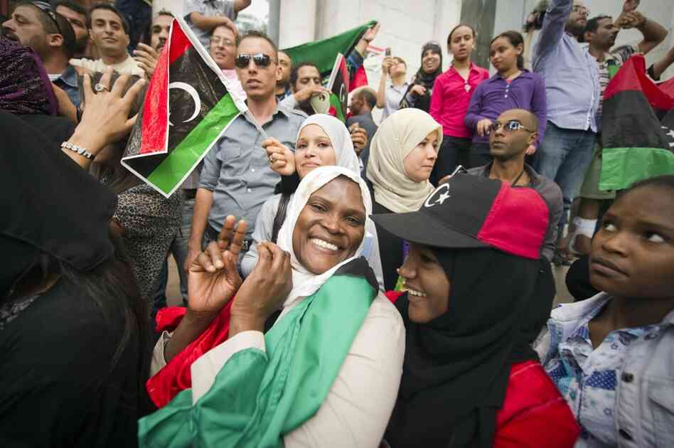 Tunisians and Libyans living in Tunisia wave Libya's National Transitional Council flags in celebration. 