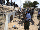 Libyan Transitional National Council fighters said Moammar Gadhafi was captured Thursday in this graffitti-filled culvert in Sirte. Libyan Transitional National Council fighters said Moammar Gadhafi was captured Thursday in this graffitti-filled culvert in Sirte.