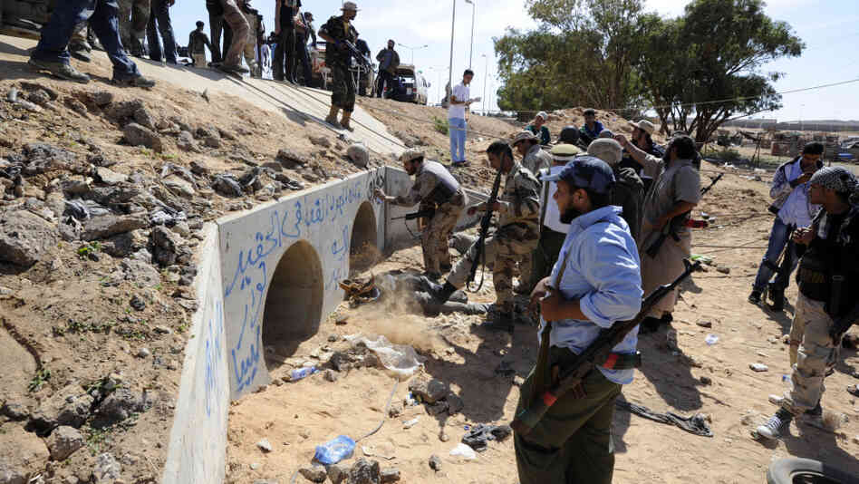 Libyan Transitional National Council fighters said Moammar Gadhafi was captured Thursday in this graffitti-filled culvert in Sirte.