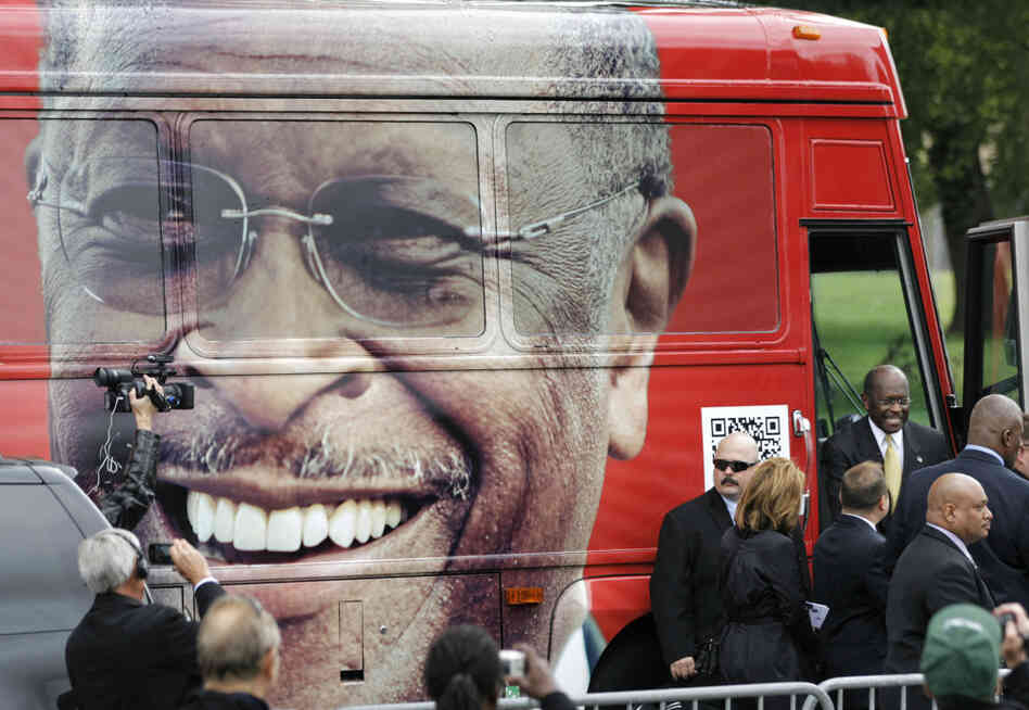 Republican presidential candidate Herman Cain steps out of his campaign bus to at a rally where he unveiled his "Opportunity Zone" economic plan in front of the Michigan Central Station, an abandoned train depot in Detroit. 