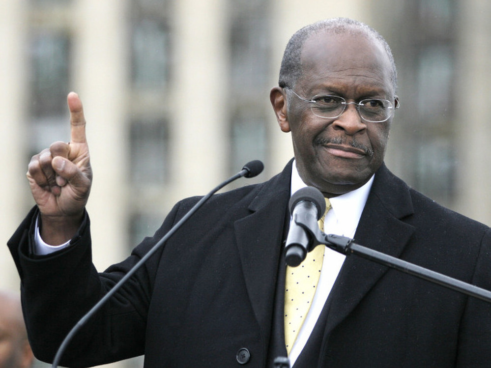 Republican presidential candidate Herman Cain speaks on Friday while unveiling his "Opportunity Zone" economic plan in front of the Michigan Central Station, an abandoned train depot in Detroit.