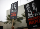 Protesters demonstrate outside the News Corp. annual shareholder meeting at Fox Studios in Los Angeles on Friday. Protesters demonstrate outside the News Corp. annual shareholder meeting at Fox Studios in Los Angeles on Friday.