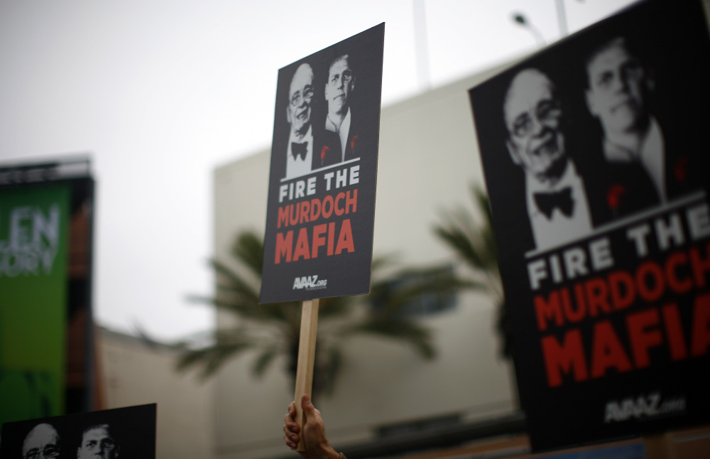 Protesters demonstrate outside the News Corp. annual shareholder meeting at Fox Studios in Los Angeles on Friday. 