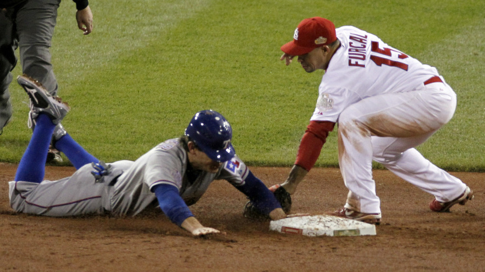 The Rangers' Ian Kinsler steals second in the ninth inning, barely beating the tag by the Cardinals' Rafael Furcal. The steal sparked a game-winning rally for Texas.