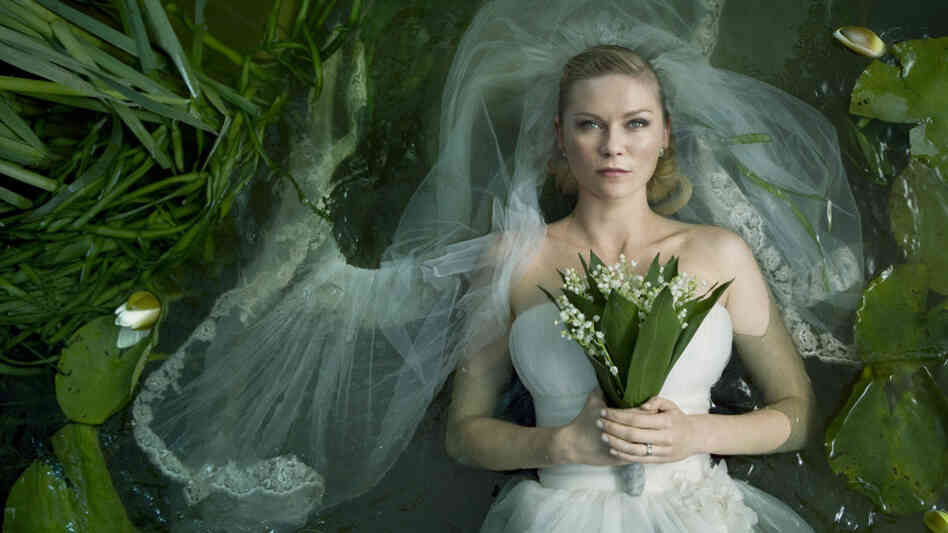 Here Bums The Bride: Lars von Trier's Melancholia centers on a newlywed (Kirsten Dunst) whose chronic depression leaves her singularly well-equipped to confront the end of the world. Here Bums The Bride: Lars von Trier's Melancholia centers on a newlywed (Kirsten Dunst) whose chronic depression leaves her singularly well-equipped to confront the end of the world.