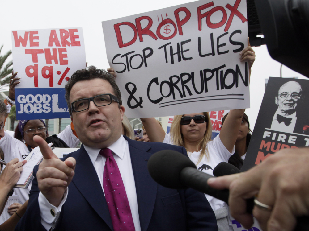 British lawmaker Tom Watson, who is leading the investigative charge into the News Corp. hacking scandal, talks to protesters outside Fox Studios.