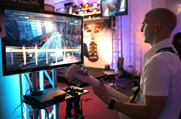 Paul Cross, creative director of Rocksmith, plays the game at a demonstration event in San Francisco, Calif.